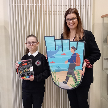 Pupil Andrei, holding coloured pens, and headteacher Karen MacKenzie, holding Andrei’s design.